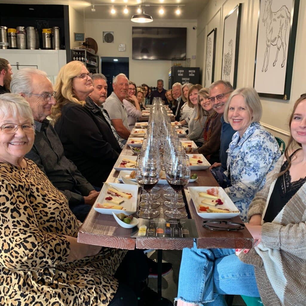Cellar 13 Winery event with a table of people with wine and cheese pairings.