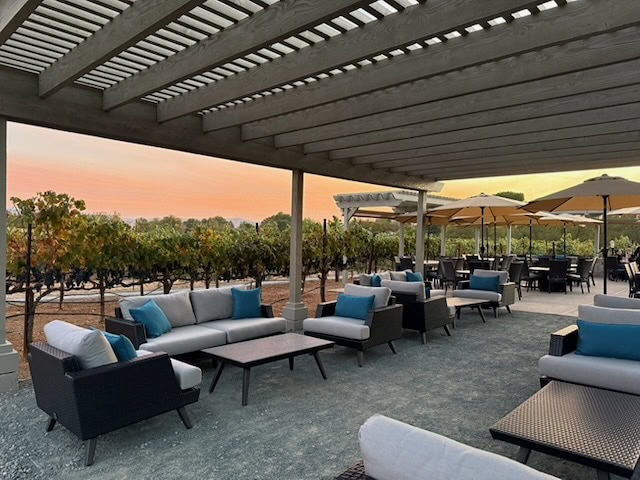 picture of cellar 13 patio with sunset behind it